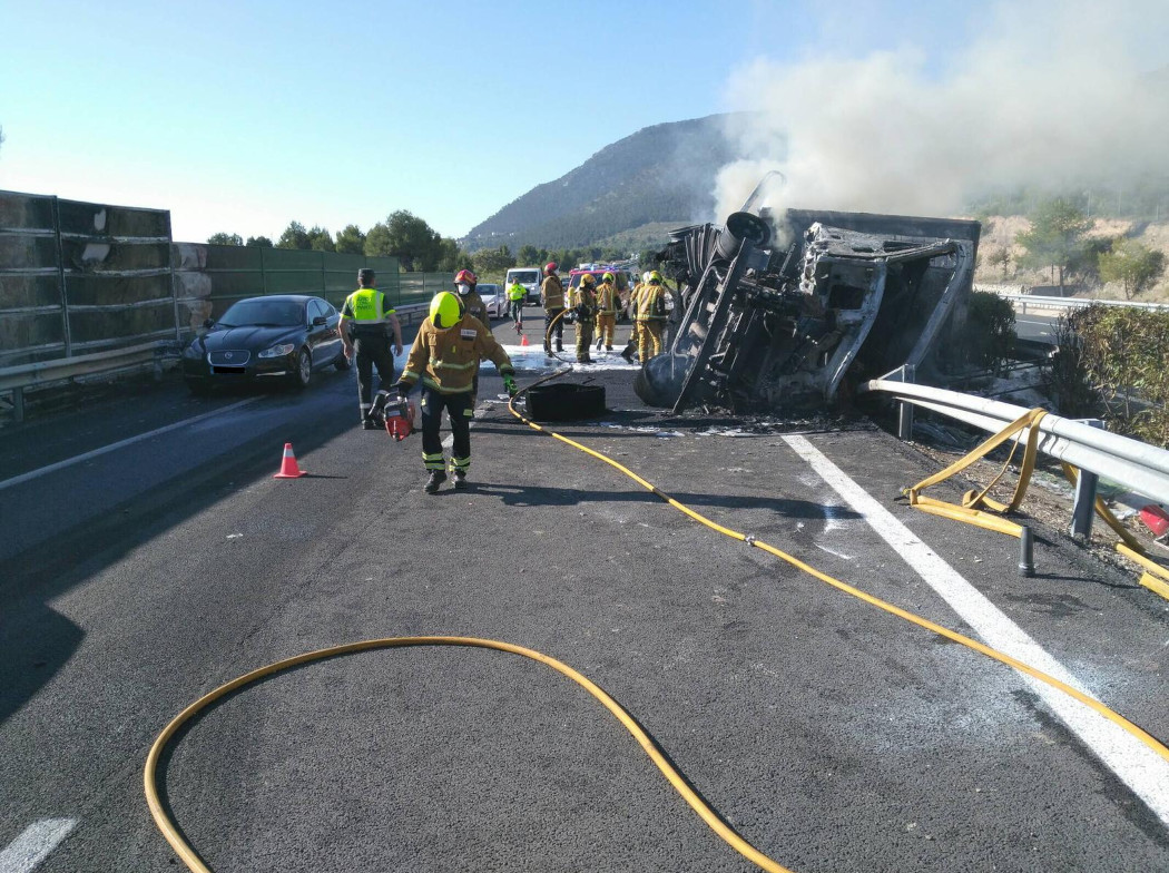 Dispositivo de bomberos atendiendo un accidente de tráfico de un camión