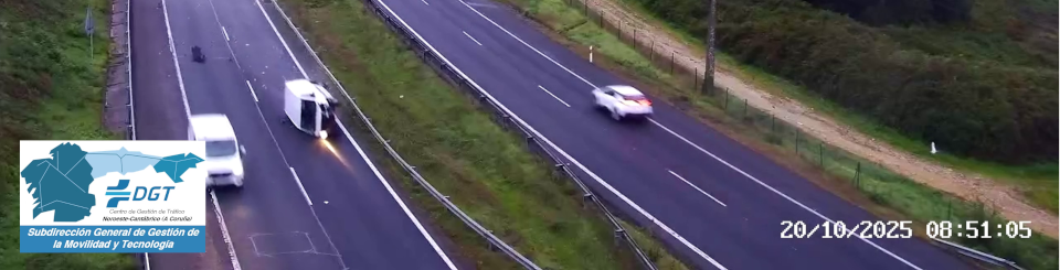 Autovía de dos carriles con coches circulando y una furgoneta volcada que bloquea uno de ellos