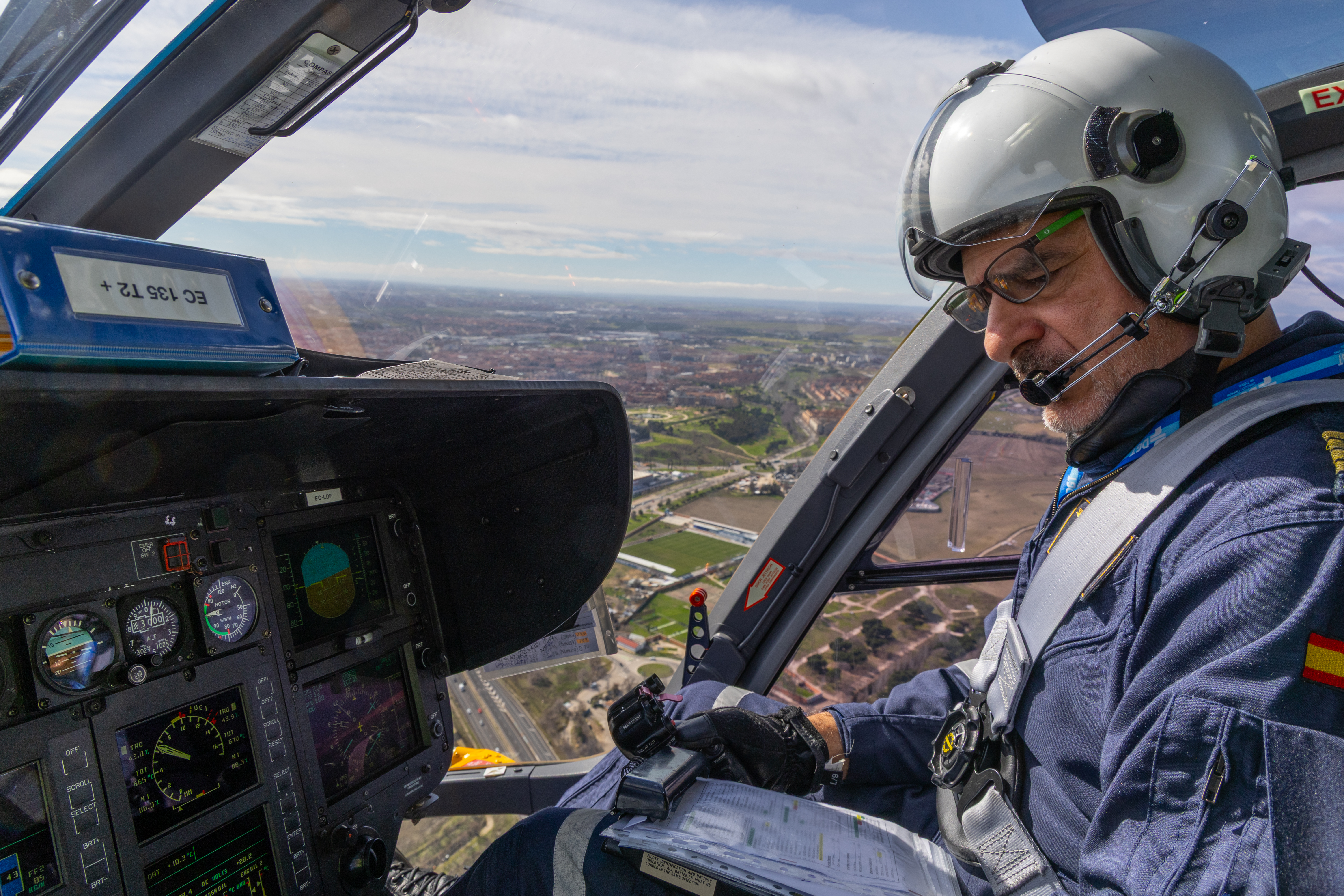 Piloto dentro de la cabina de un helicóptero en pleno vuelo. 